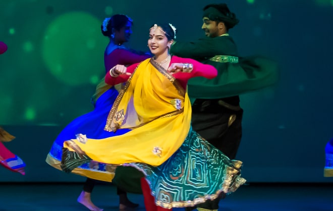 Girl wearing a beautiful dance costume and performing Garba.