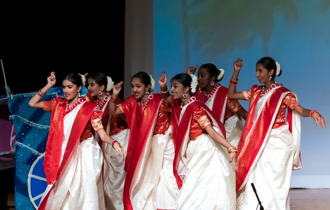 NSDA students wearing beautiful red sari attires.