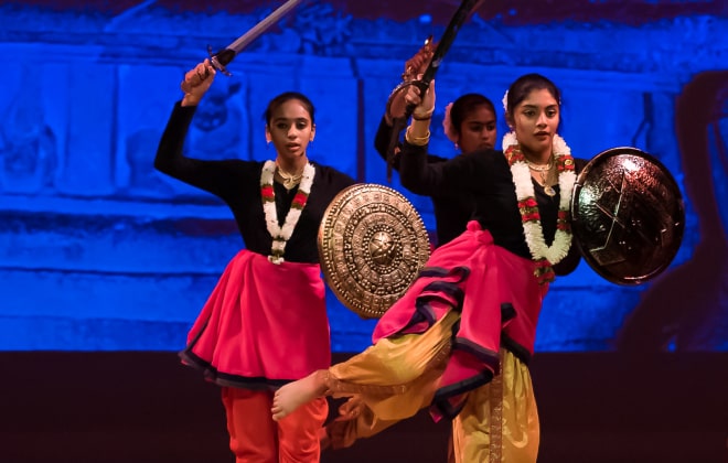 Student brandishing a sword in a martial art folk dance.