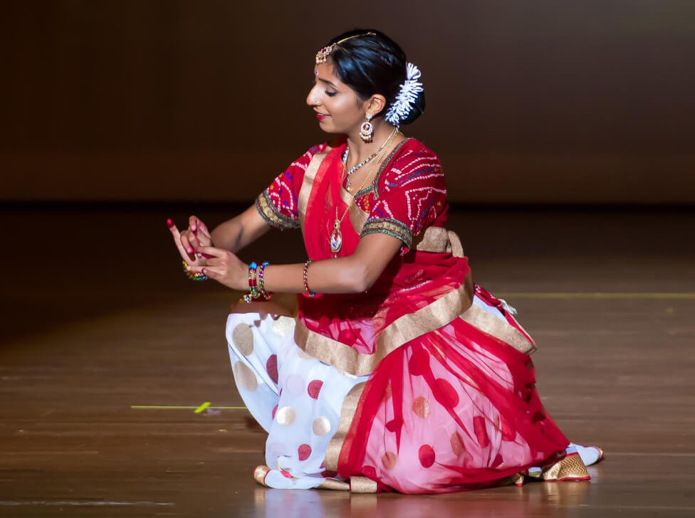 A NSDA elite student showcasing footwork and mudras on stage.