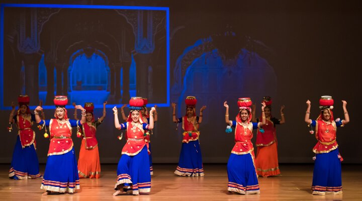 Students in a beautiful dance formation on stage.