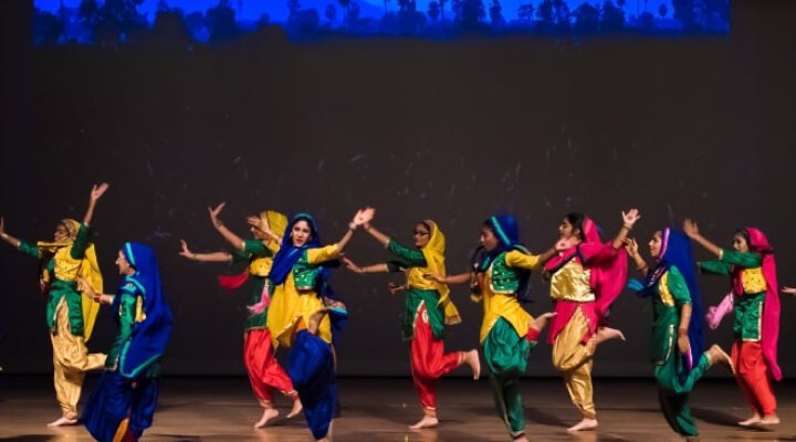 NSDA student performing Bhangra on stage.
