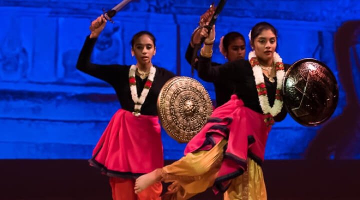 NSDA students performing Than-Ta with swords on stage.